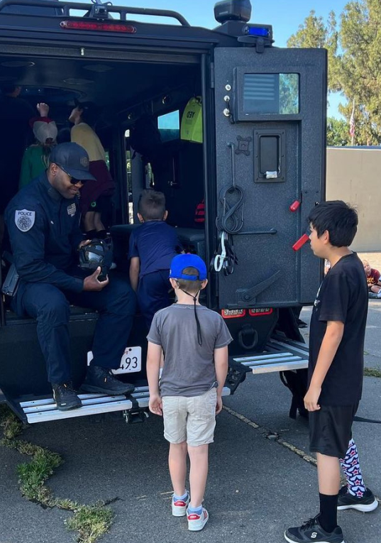 youth looking at a officers vehicle